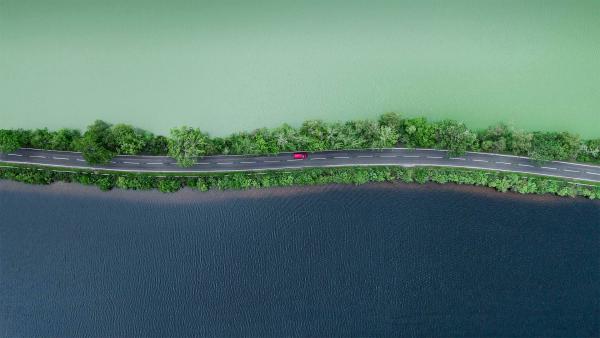 Aerial view of a road separating two lakes in the Scottish Highlands (© Abstract