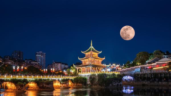 Jiaxiu Tower under a full moon, Guiyang, Guizhou province, China (© Wang