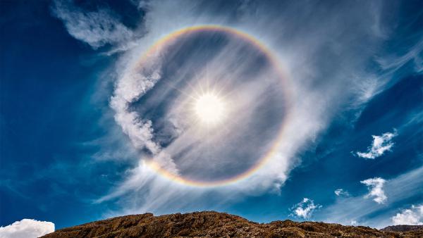 Sun halo over Lake Antermoia in the Dolomite Mountains of Italy (© Walter