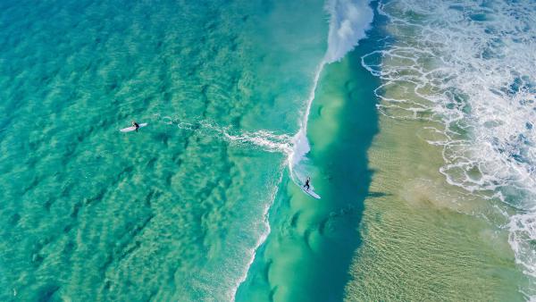 Surfers catching waves at Palm Beach on the Gold Coast, Queensland, Australia (©