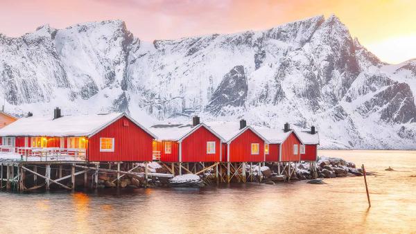 Traditional red fishermen's cabins on the shore of Reinefjorden, Norway (©