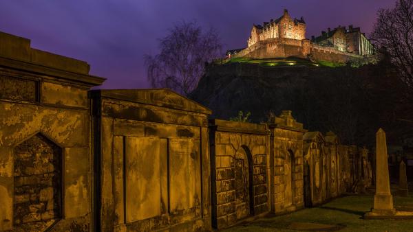 View of Edinburgh Castle from a churchyard in Scotland (© Chris Dorney/Alamy)